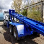 A photo showing a just painted JT Fabrication Roll Off Container Truck Body